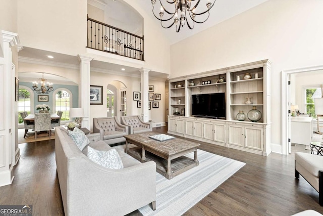 100 Pine Mist Cir, Alpharetta, GA 30022 - living room with a chandelier, a towering ceiling, dark wood-style floors, ornamental molding, and baseboards