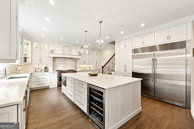 100 Pine Mist Cir, Alpharetta, GA 30022 - kitchen featuring high end appliances, beverage cooler, a sink, a kitchen island, and white cabinets