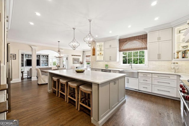 100 Pine Mist Cir, Alpharetta, GA 30022 - kitchen featuring a chandelier, a sink, decorative columns, crown molding, and tasteful backsplash