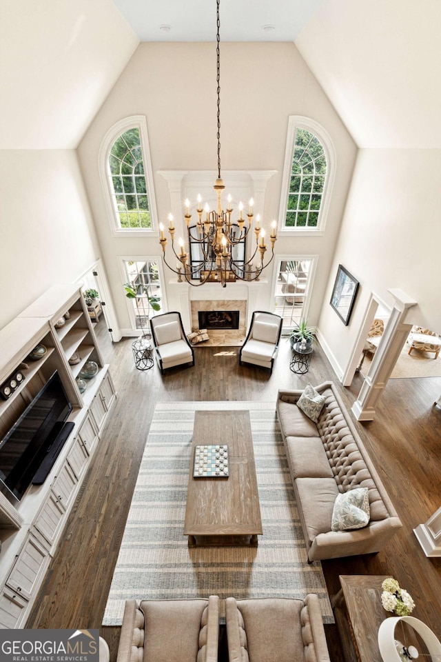 100 Pine Mist Cir, Alpharetta, GA 30022 - living room featuring high vaulted ceiling, healthy amount of natural light, wood finished floors, a chandelier, and a fireplace