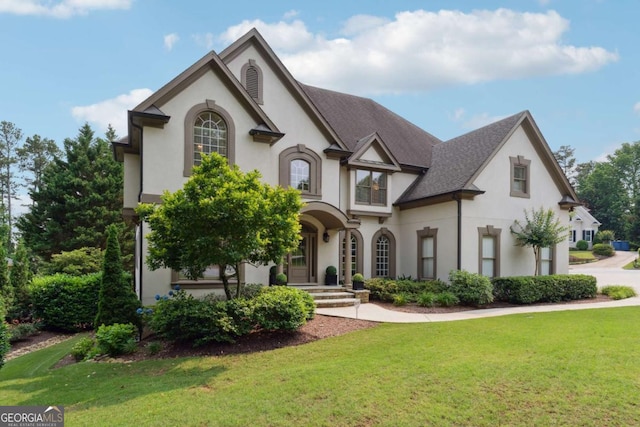 100 Pine Mist Cir, Alpharetta, GA 30022 - view of front of home with stucco siding, a front yard, and roof with shingles