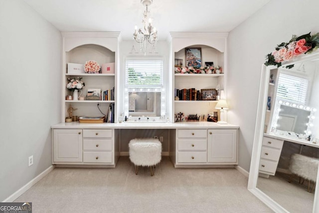 100 Pine Mist Cir, Alpharetta, GA 30022 - office with built in study area, a chandelier, light colored carpet, and built in shelves
