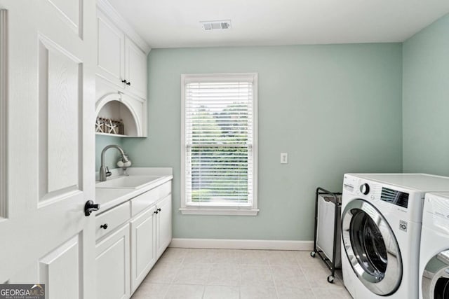100 Pine Mist Cir, Alpharetta, GA 30022 - laundry area featuring washing machine and clothes dryer, plenty of natural light, cabinet space, and baseboards