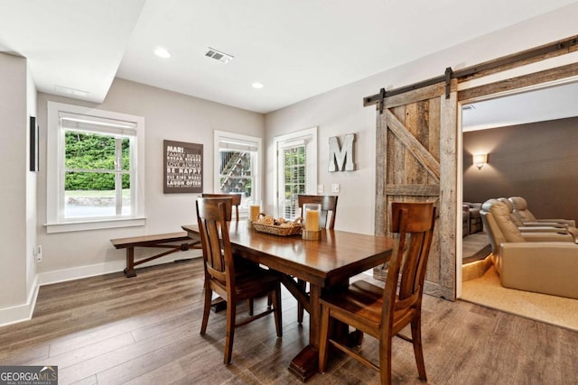 100 Pine Mist Cir, Alpharetta, GA 30022 - dining room with healthy amount of natural light, wood finished floors, baseboards, recessed lighting, and a barn door