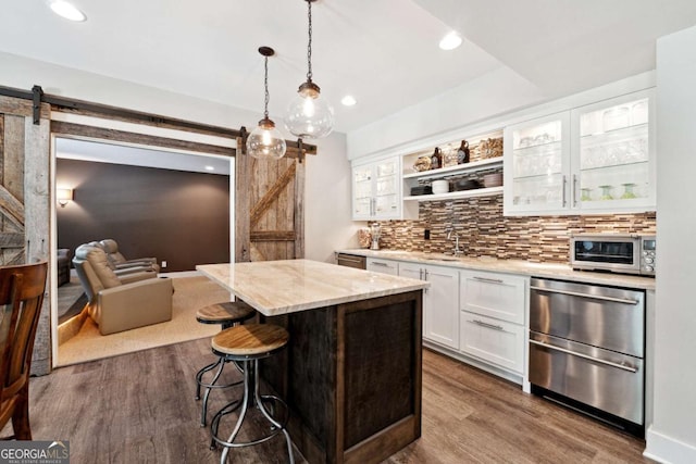 100 Pine Mist Cir, Alpharetta, GA 30022 - kitchen with a barn door, dishwasher, dark wood-style floors, white cabinets, and a breakfast bar area