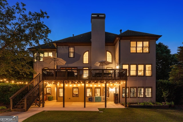 100 Pine Mist Cir, Alpharetta, GA 30022 - back of house at twilight featuring a patio, stucco siding, a chimney, and a yard