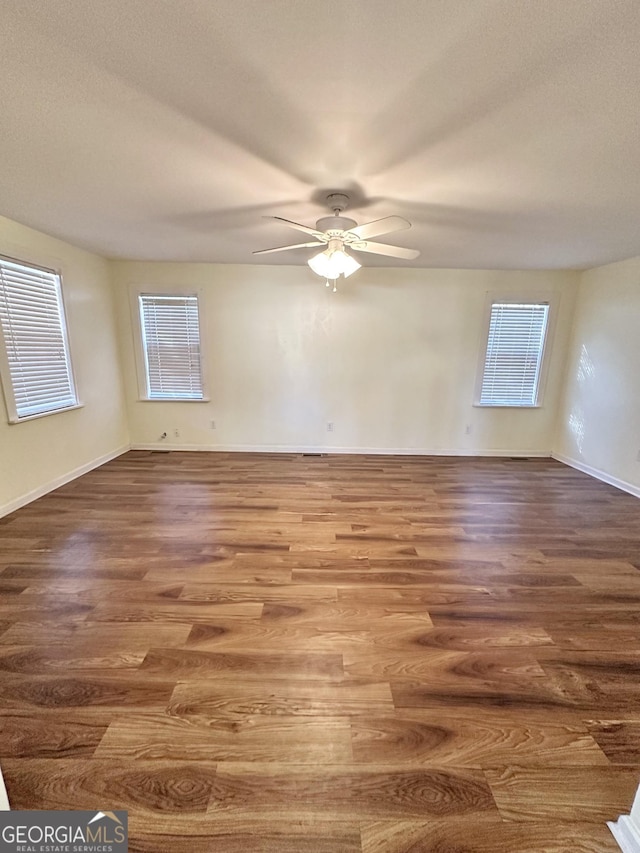109 Flat Rock Ln, Eatonton, GA 31024 - unfurnished room featuring a ceiling fan, wood finished floors, plenty of natural light, and baseboards
