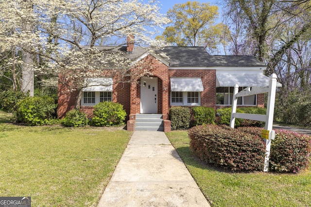 109 Stockbridge Rd, Jonesboro, GA 30236 - view of front of home featuring a front lawn, brick siding, and a chimney