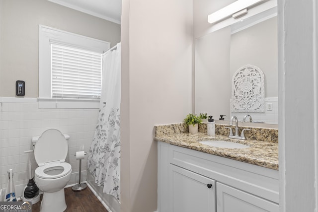 109 Stockbridge Rd, Jonesboro, GA 30236 - full bathroom with vanity, toilet, wood finished floors, tile walls, and a shower with curtain