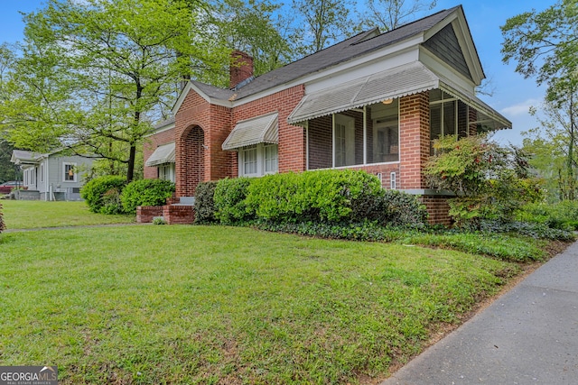 109 Stockbridge Rd, Jonesboro, GA 30236 - view of front of home with brick siding, a front lawn, and a chimney