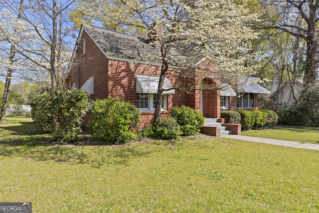 109 Stockbridge Rd, Jonesboro, GA 30236 - view of front of property featuring brick siding, a front lawn, and roof with shingles