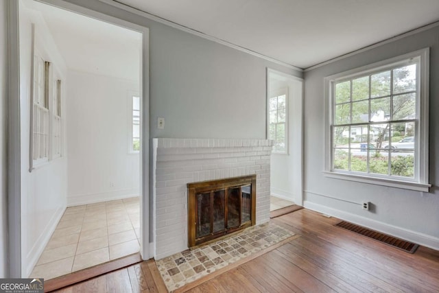 170 Stanton Way, Athens, GA 30606 - unfurnished living room featuring hardwood / wood-style flooring, a brick fireplace, and ornamental molding