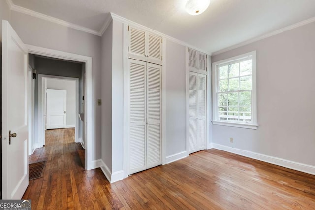 170 Stanton Way, Athens, GA 30606 - unfurnished bedroom featuring crown molding, hardwood / wood-style floors, and multiple closets