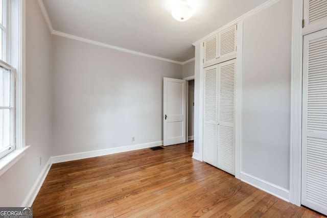 170 Stanton Way, Athens, GA 30606 - unfurnished bedroom featuring multiple closets, light wood-style floors, and crown molding