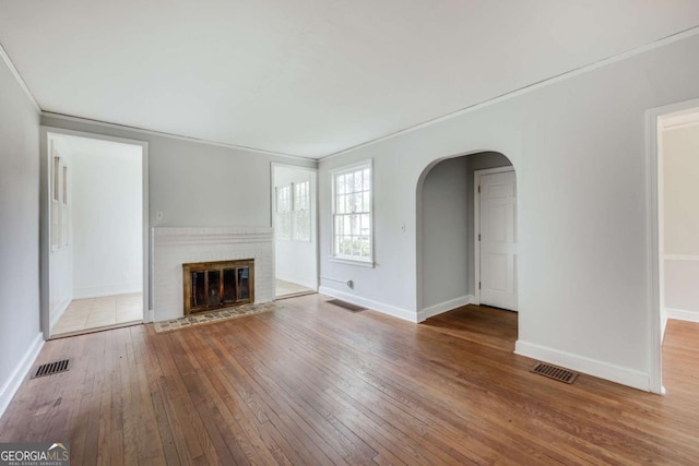 170 Stanton Way, Athens, GA 30606 - unfurnished living room featuring arched walkways, hardwood / wood-style flooring, ornamental molding, baseboards, and a fireplace