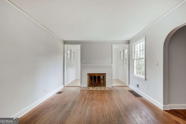 170 Stanton Way, Athens, GA 30606 - unfurnished living room featuring arched walkways, hardwood / wood-style flooring, a fireplace, and ornamental molding
