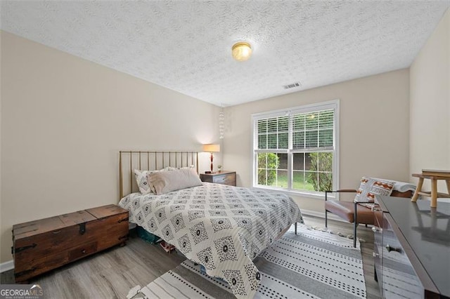 1865 Morgans Run Trl, Buford, GA 30519 - bedroom with wood finished floors and a textured ceiling