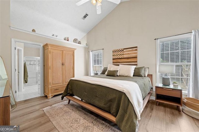 1865 Morgans Run Trl, Buford, GA 30519 - bedroom with high vaulted ceiling, light wood-type flooring, ceiling fan, and connected bathroom