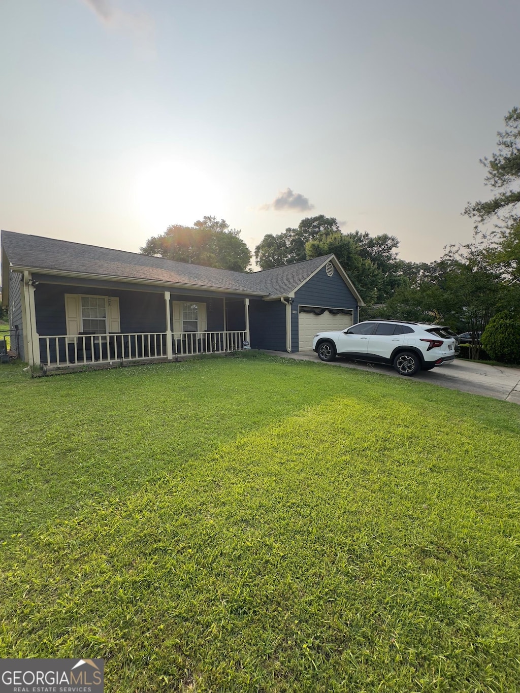 6403 Heritage Run, Morrow, GA 30260 - view of front facade featuring a garage, a yard, covered porch, and concrete driveway