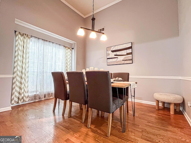 329 Royal Crescent Way, Stockbridge, GA 30281 - dining space featuring ornamental molding, baseboards, wood finished floors, and a high ceiling