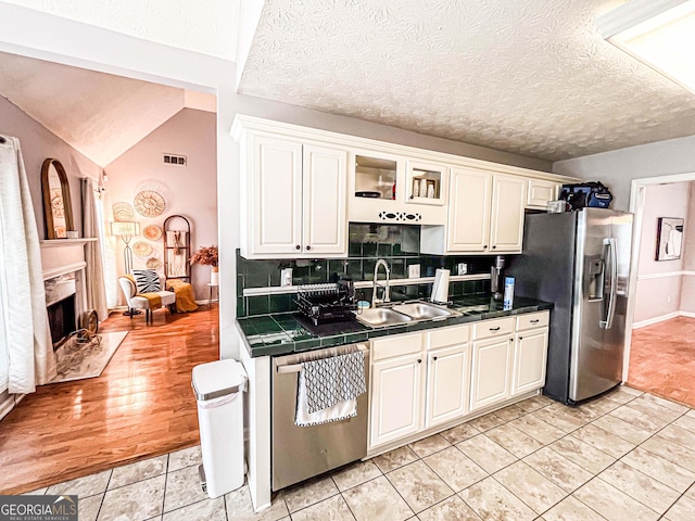 329 Royal Crescent Way, Stockbridge, GA 30281 - kitchen with stainless steel appliances, a sink, white cabinets, tile countertops, and tasteful backsplash
