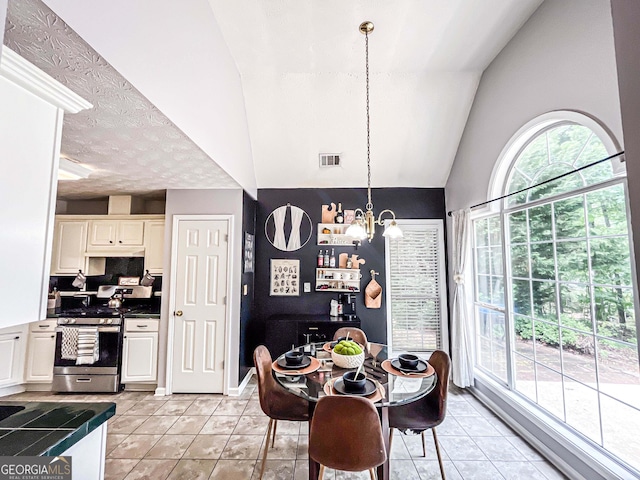 329 Royal Crescent Way, Stockbridge, GA 30281 - dining room featuring a chandelier, light tile patterned flooring, and vaulted ceiling