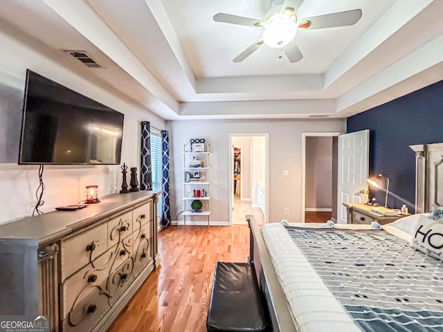 329 Royal Crescent Way, Stockbridge, GA 30281 - bedroom featuring light wood-style floors, a tray ceiling, ceiling fan, and baseboards
