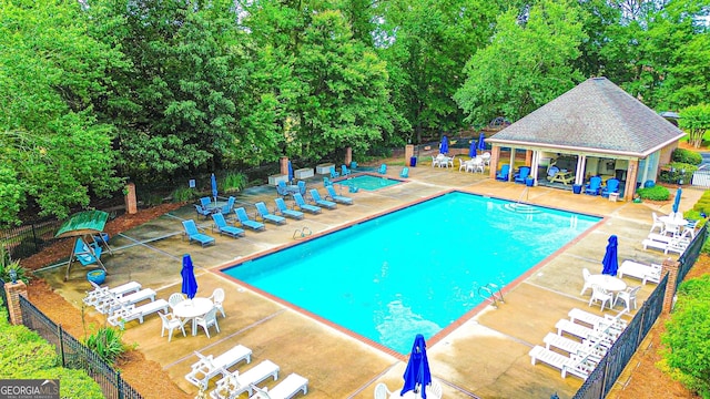 329 Royal Crescent Way, Stockbridge, GA 30281 - community pool with a patio area, an outbuilding, and view of scattered trees