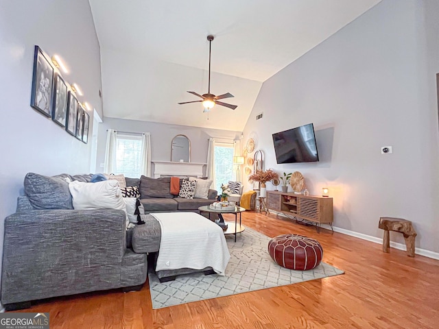 329 Royal Crescent Way, Stockbridge, GA 30281 - living room featuring a ceiling fan, wood finished floors, high vaulted ceiling, and baseboards