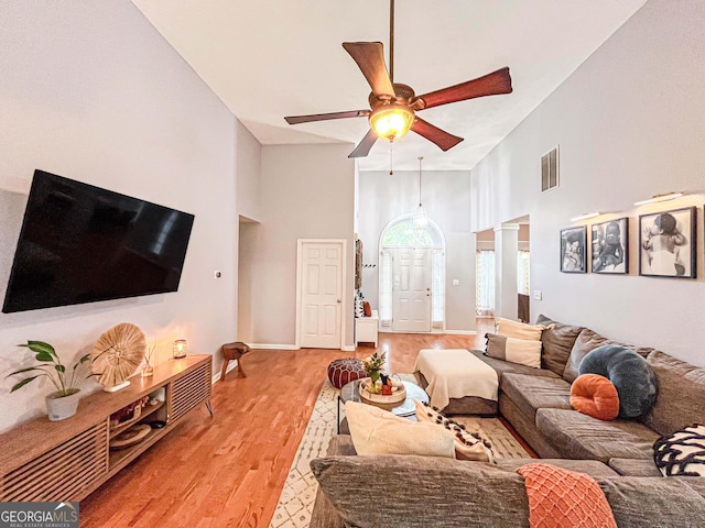 329 Royal Crescent Way, Stockbridge, GA 30281 - living area featuring high vaulted ceiling, light wood finished floors, ceiling fan, decorative columns, and baseboards