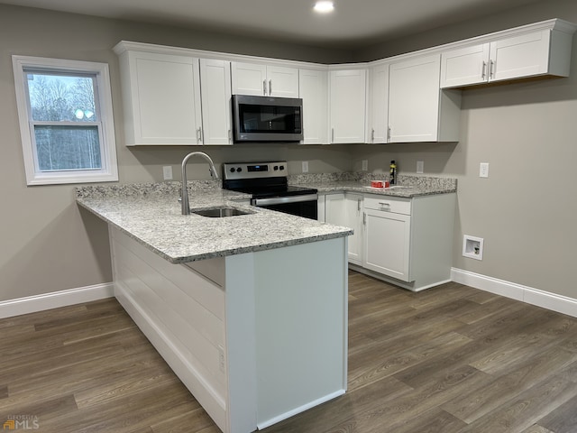 1679 Rock Rd, Mount Airy, GA 30563 - kitchen featuring stainless steel appliances, a sink, a peninsula, light stone countertops, and baseboards