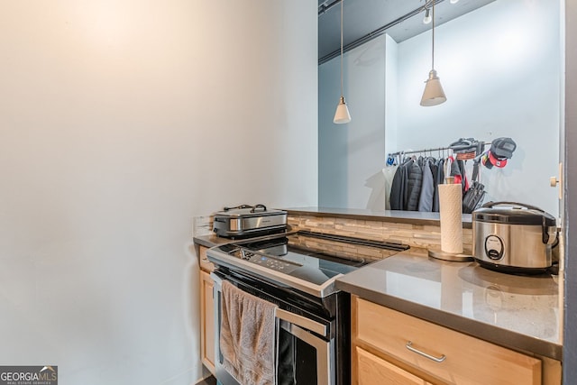 120 Ralph Mcgill Blvd NE Unit 1502, Atlanta, GA 30308 - kitchen with stainless steel electric range oven, light brown cabinetry, and hanging light fixtures