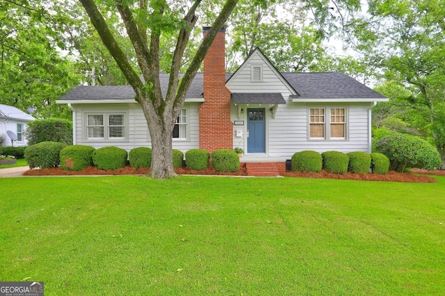 926 Thomaston St, Barnesville, GA 30204 - view of front facade with a front yard, a chimney, and a shingled roof
