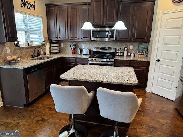 860 Nevis Way, Mcdonough, GA 30253 - kitchen with appliances with stainless steel finishes, a sink, dark wood finished floors, and dark brown cabinetry