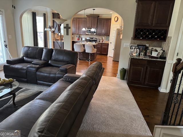860 Nevis Way, Mcdonough, GA 30253 - living room with arched walkways, dark wood-type flooring, and plenty of natural light
