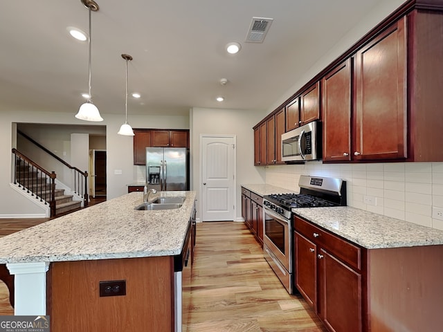 471 Lanier Ct, Hiram, GA 30141 - kitchen with appliances with stainless steel finishes, a sink, light wood finished floors, tasteful backsplash, and recessed lighting