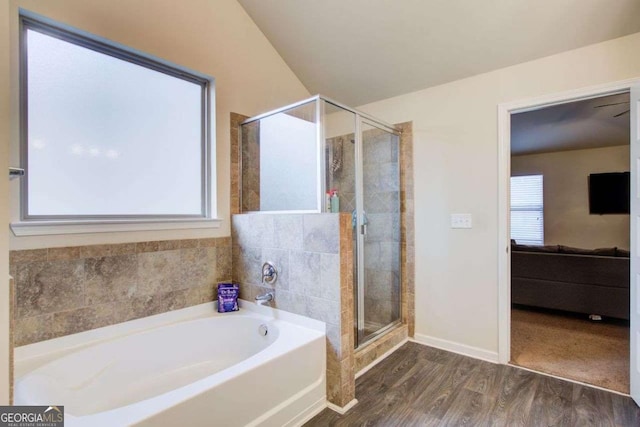3746 Okefenokee Rdg, Loganville, GA 30052 - bathroom featuring a bath, a shower stall, and wood finished floors