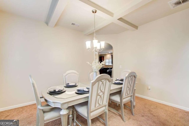 3746 Okefenokee Rdg, Loganville, GA 30052 - carpeted dining space featuring beam ceiling, a chandelier, and arched walkways