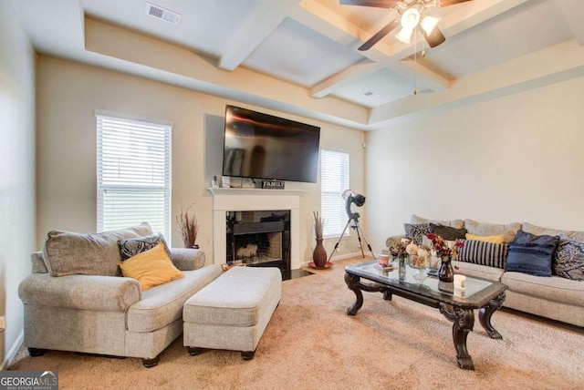 3746 Okefenokee Rdg, Loganville, GA 30052 - carpeted living area with coffered ceiling, a ceiling fan, beam ceiling, and a fireplace with flush hearth