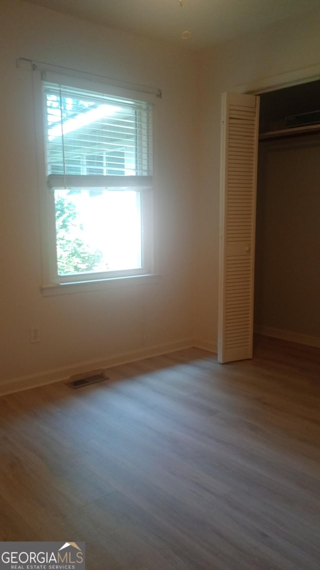 61 Maxie Ln, Dallas, GA 30157 - unfurnished bedroom featuring wood finished floors and a closet