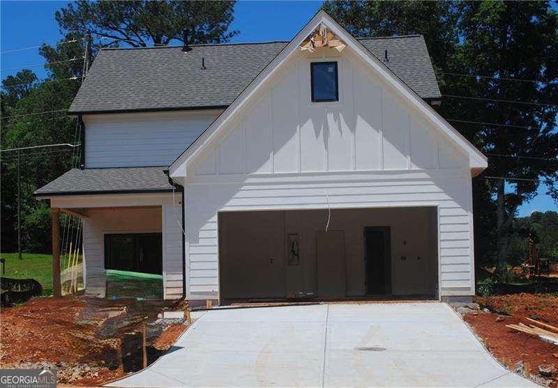 125 Old Alabama Rd, Emerson, GA 30137 - view of front of home featuring board and batten siding, driveway, a garage, and roof with shingles