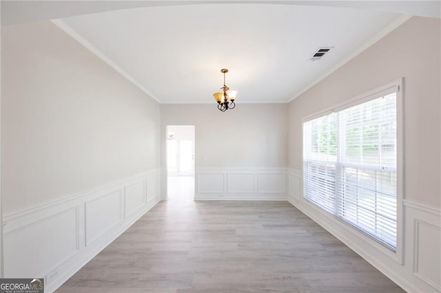 436 Crestmont Ln, Canton, GA 30114 - unfurnished room featuring a chandelier, crown molding, a decorative wall, and light wood-type flooring