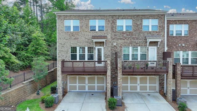 747 Topsail Ln, Alpharetta, GA 30005 - townhome / multi-family property with concrete driveway, a garage, and brick siding