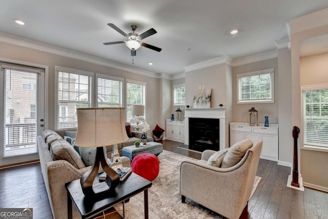 747 Topsail Ln, Alpharetta, GA 30005 - living area with a fireplace with raised hearth, dark wood-style floors, a ceiling fan, crown molding, and recessed lighting