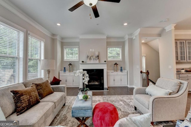 747 Topsail Ln, Alpharetta, GA 30005 - living room featuring wood finished floors, healthy amount of natural light, ceiling fan, a glass covered fireplace, and crown molding