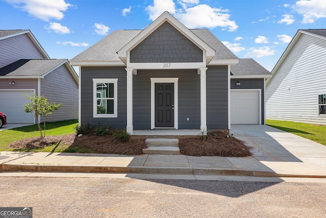 215 Lenox Cir, Lagrange, GA 30241 - view of front of home with an attached garage, concrete driveway, a shingled roof, and a porch
