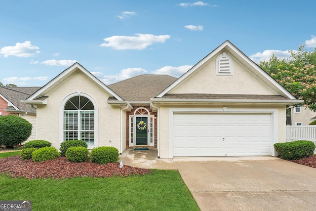412 Rock Creek Dr, Peachtree City, GA 30269 - view of front facade with stucco siding, concrete driveway, an attached garage, a shingled roof, and a front lawn