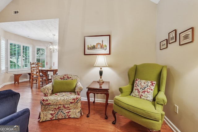 412 Rock Creek Dr, Peachtree City, GA 30269 - living area featuring a chandelier, baseboards, wood finished floors, and lofted ceiling