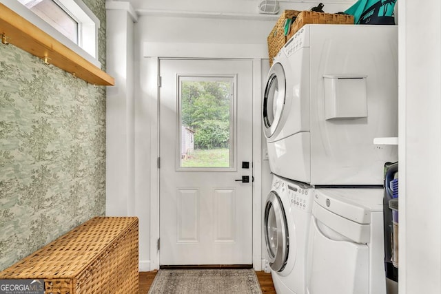 575 E Main St, Buford, GA 30518 - washroom with stacked washer and clothes dryer, dark wood-style flooring, and wallpapered walls