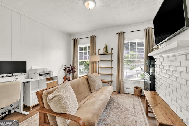 575 E Main St, Buford, GA 30518 - living area featuring wood finished floors, an office area, a textured ceiling, and crown molding